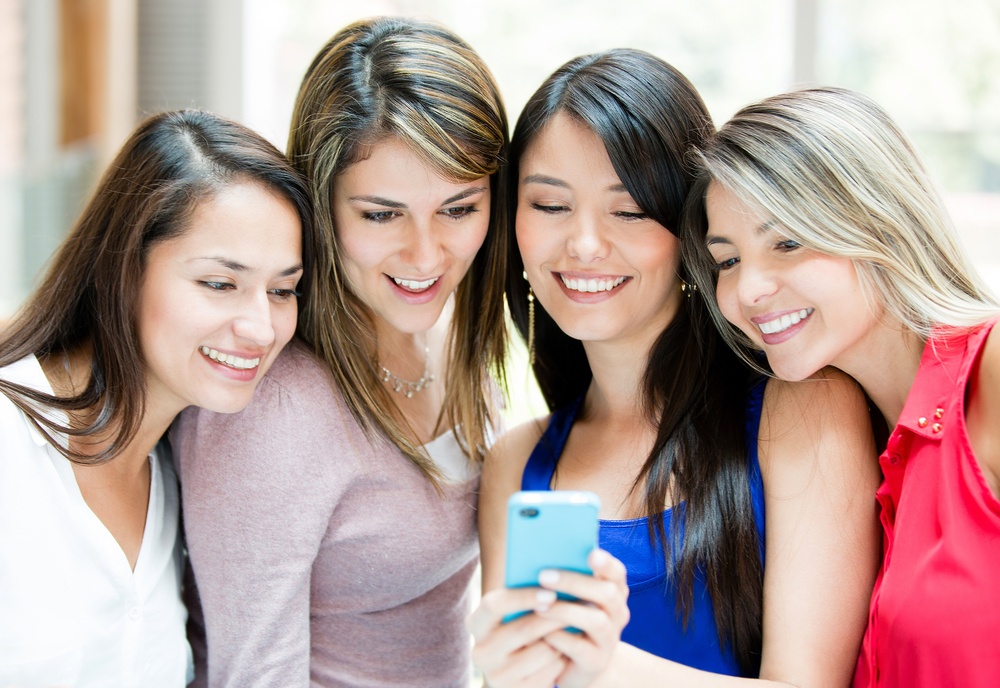 Group of girls looking at a cell phone